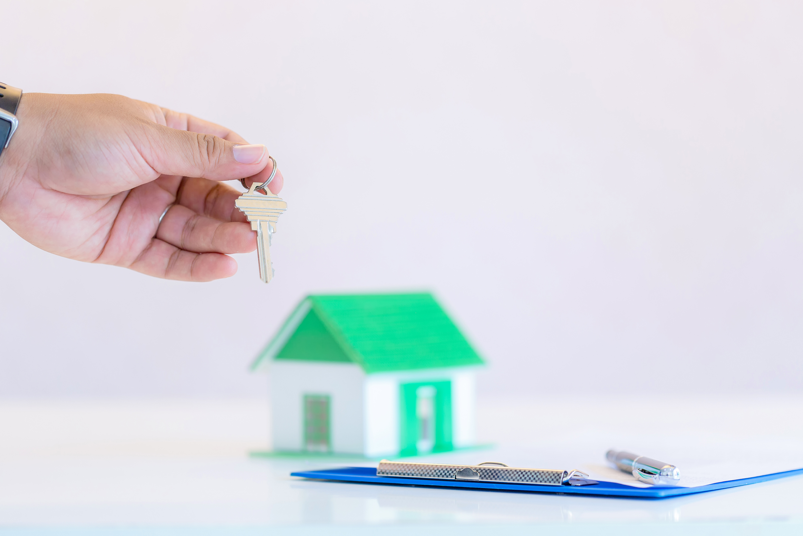 Male businessman holding, giving house keys, close up of hand, i