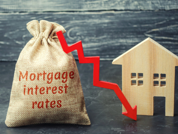 Bag with the money and the word Mortgage interest rates and arrow to down and house. Low interest in mortgages. Reducing interest payments for mortgages. The fall in housing rates on credit. Low housing demand